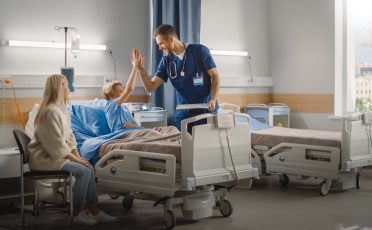 Hospital,Ward:,Handsome,Young,Boy,Resting,In,Bed,With,Caring